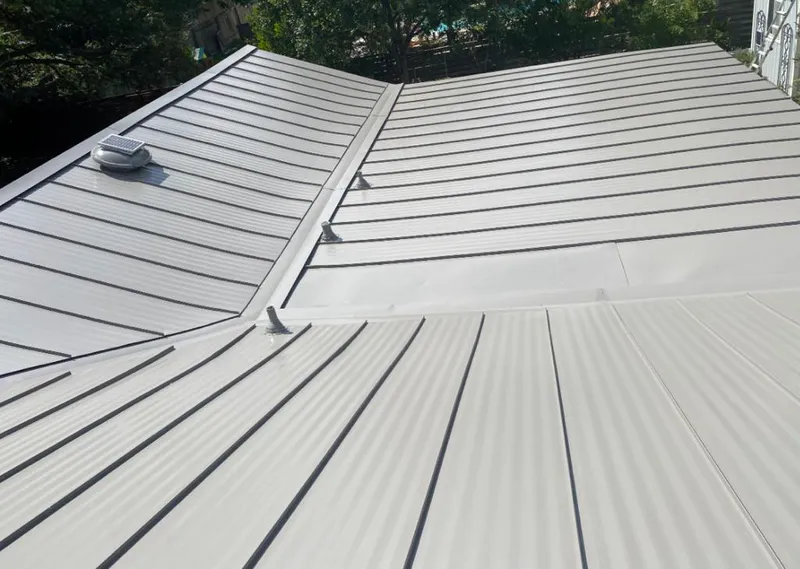 Solar attic fan installed on a metal roof for Roof Ventilation in Lake Mary